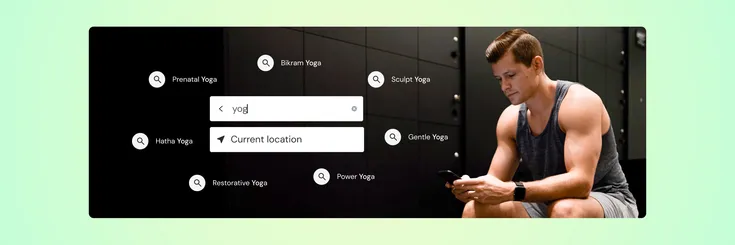 man sitting on workout bench looking on the mindbody app