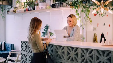 Client checking out at front desk of a spa