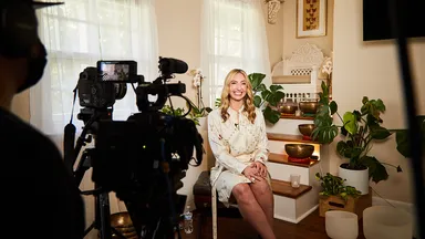 woman filming video for wellness business