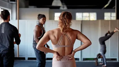 woman and men working out in gym