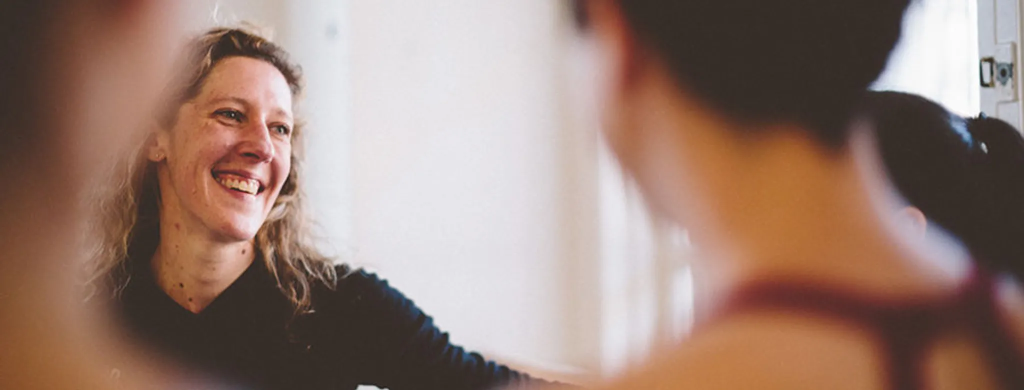 Person laughing while talking to client