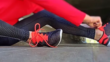 Woman tying running shoes