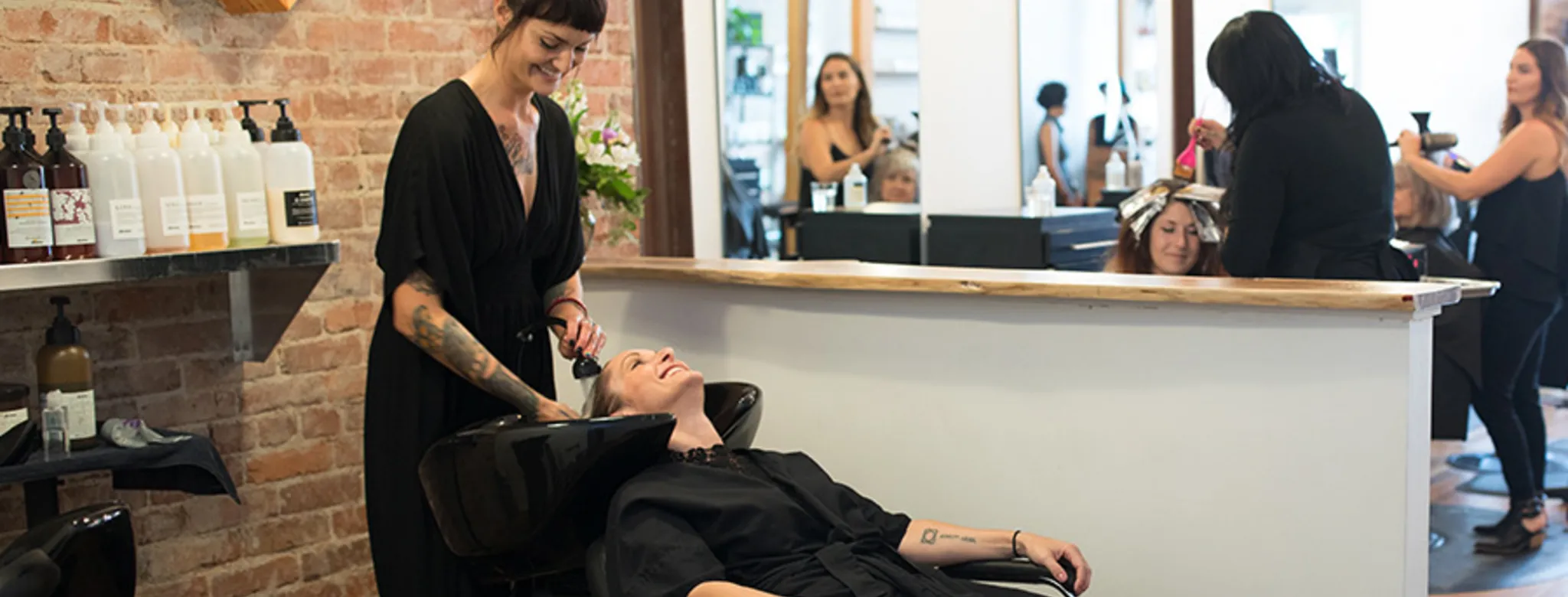 Woman washing hair in a salon