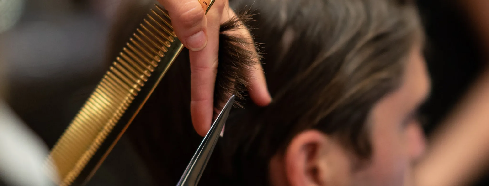 Stylist cutting hair at Emerson Joseph