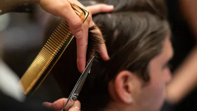 Stylist cutting hair at Emerson Joseph