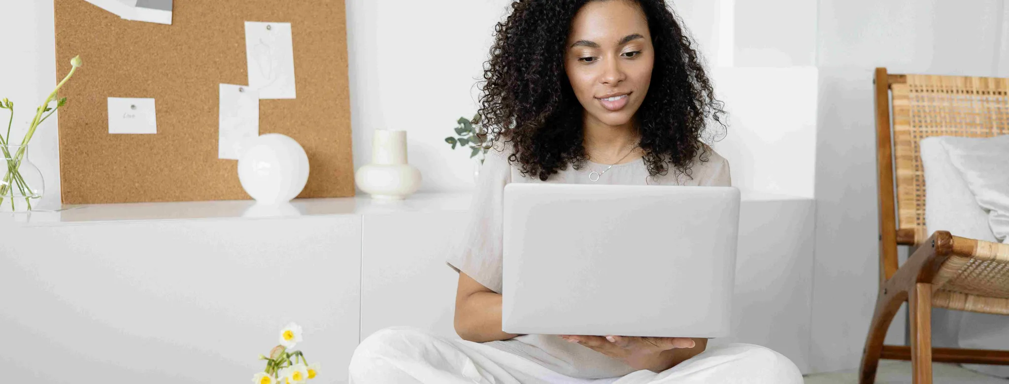 Gym owner in white pants looking at laptop