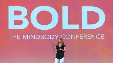 Presenter discussing wellness industry trends at BOLD
