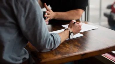 Two people working on a business plan