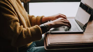 woman typing on laptop