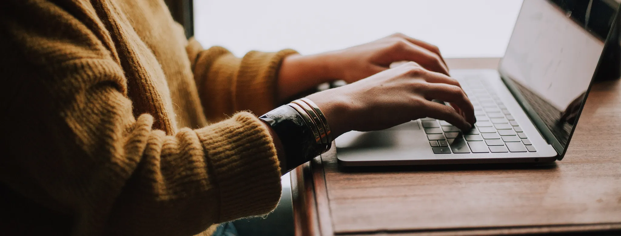 woman typing on laptop
